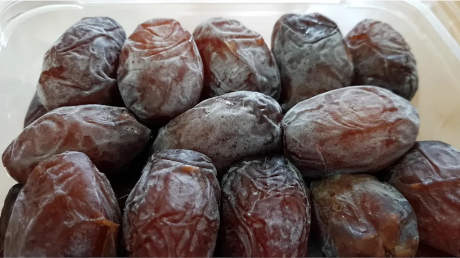 Close-up of moist Medjool dates in a clear container